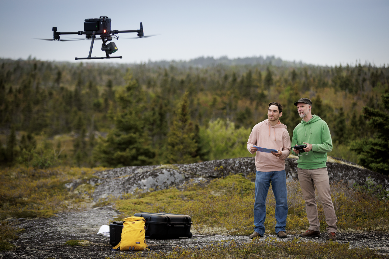 Geography student at field study working a drone
